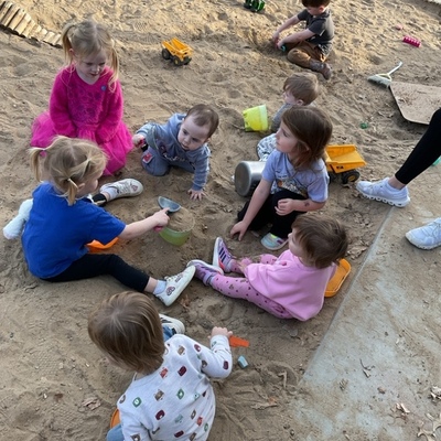 Sand box playing with siblings