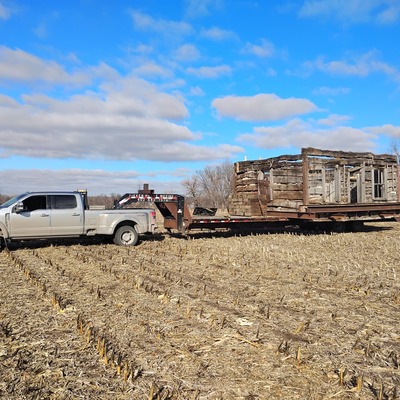 Tim Tieken moving the Log Cabin across the Corn Field