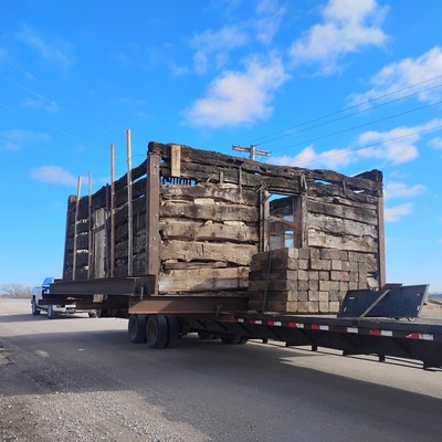 Log Cabin going down the road